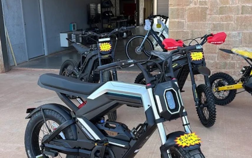 Electric dirt bikes and e-motos displayed inside the Abilene showroom
