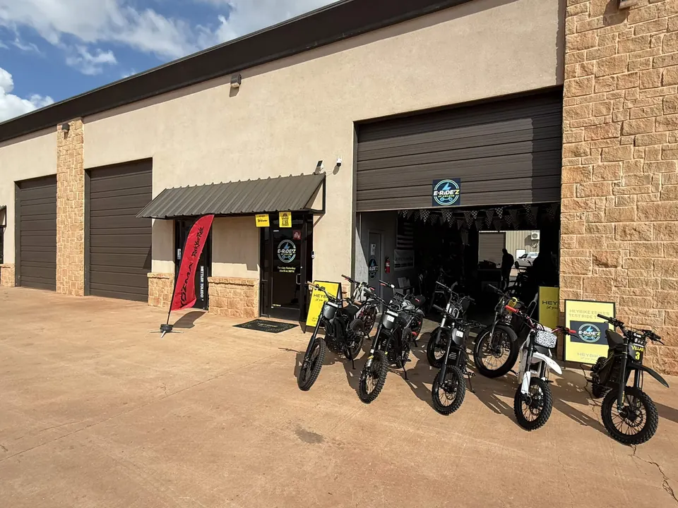 Electric dirt bikes displayed outside the open E-Ride'z of Abilene showroom