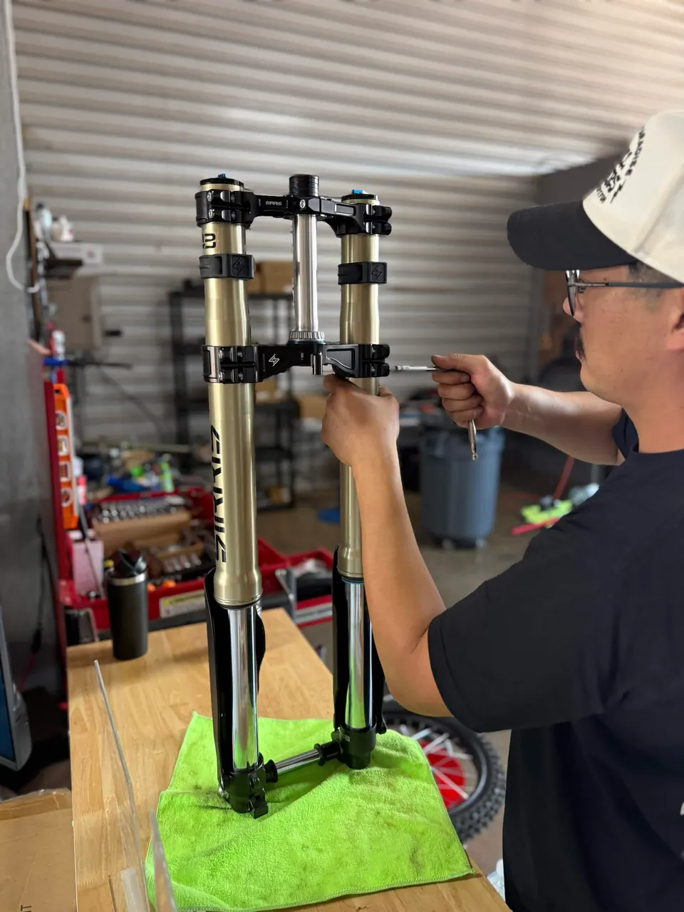 A mechanic working on suspension forks at the E-Ride'z of Abilene workbench