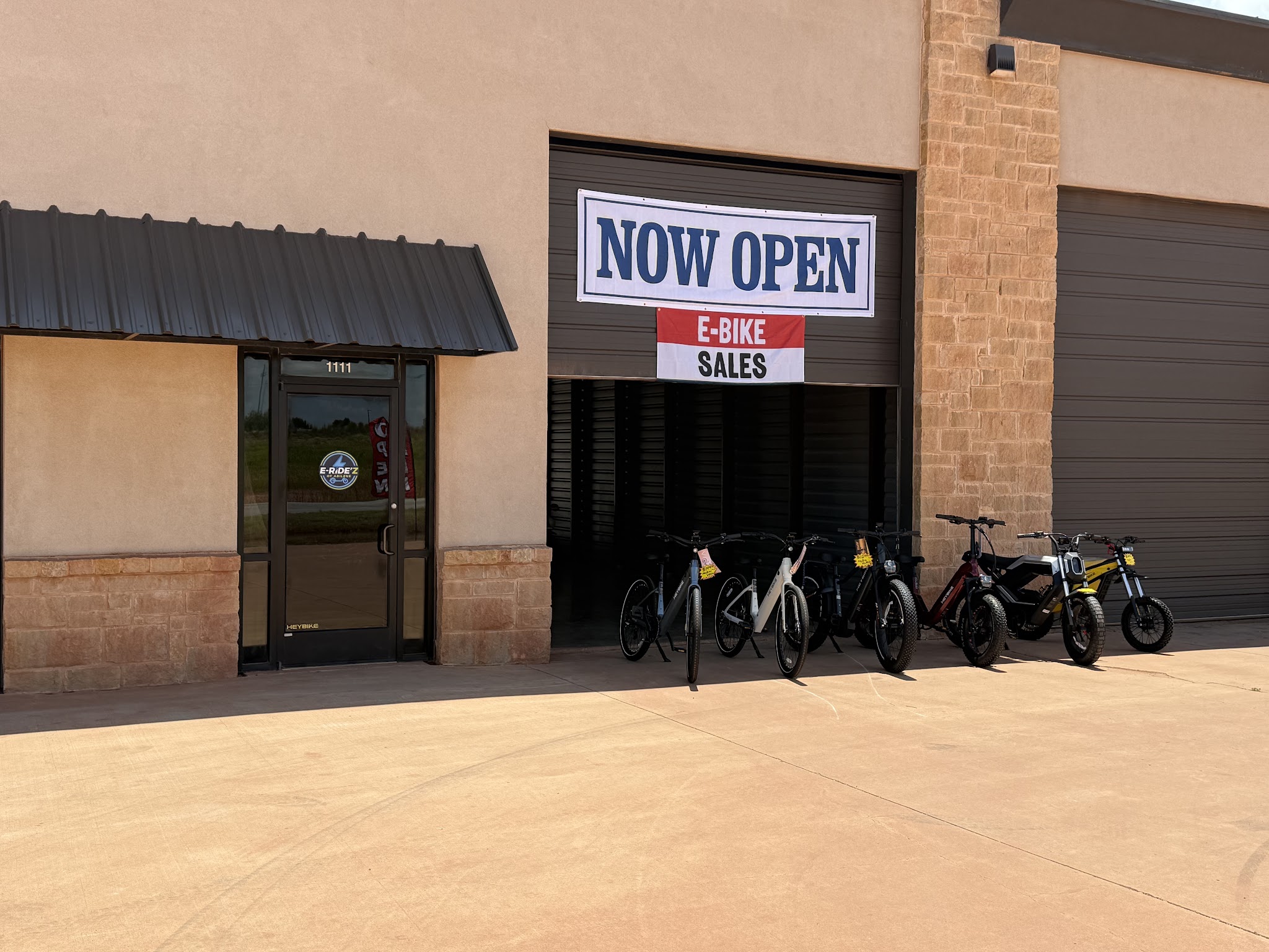 The E-Ride'z storefront on US-83 with the NOW OPEN banner